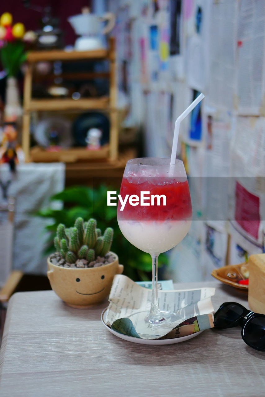 CLOSE-UP OF DRINK WITH JUICE ON TABLE