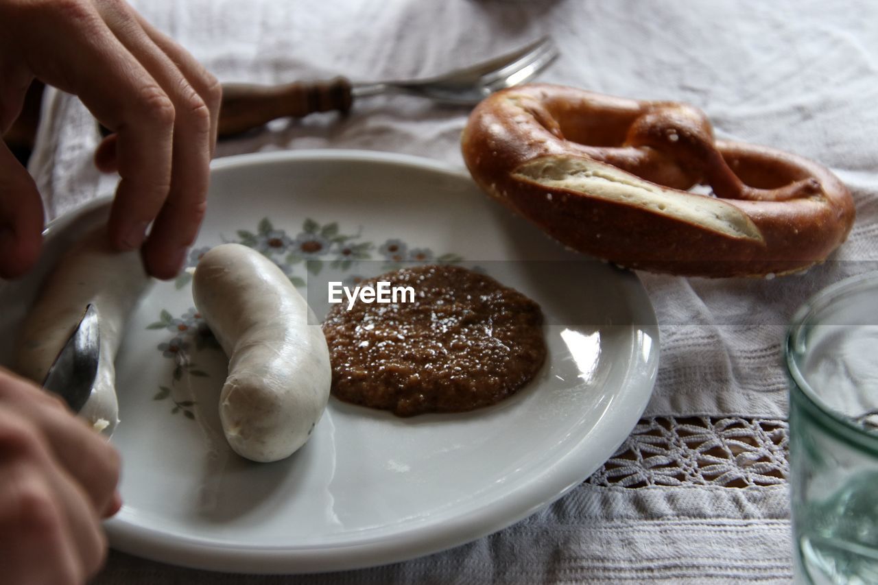 High angle view of hand holding bread in plate