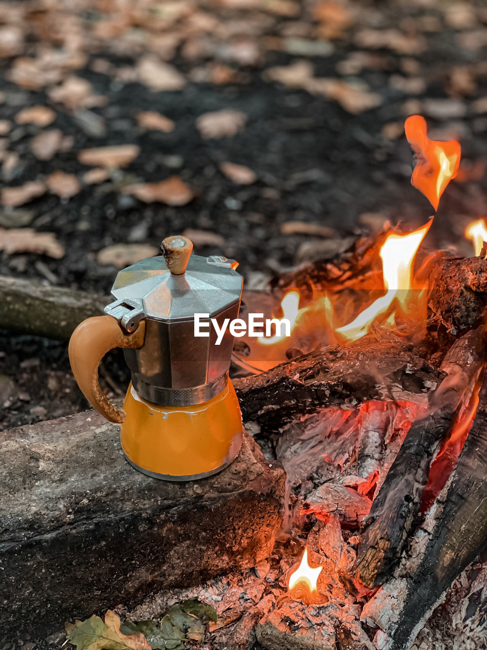 Small thing meters, fire, mokapot, coffee in forest.