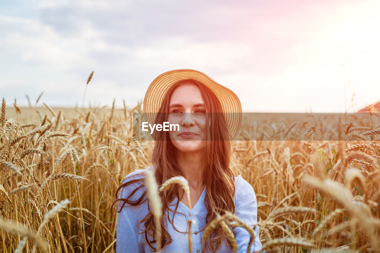 Portrait of young woman standing in farm