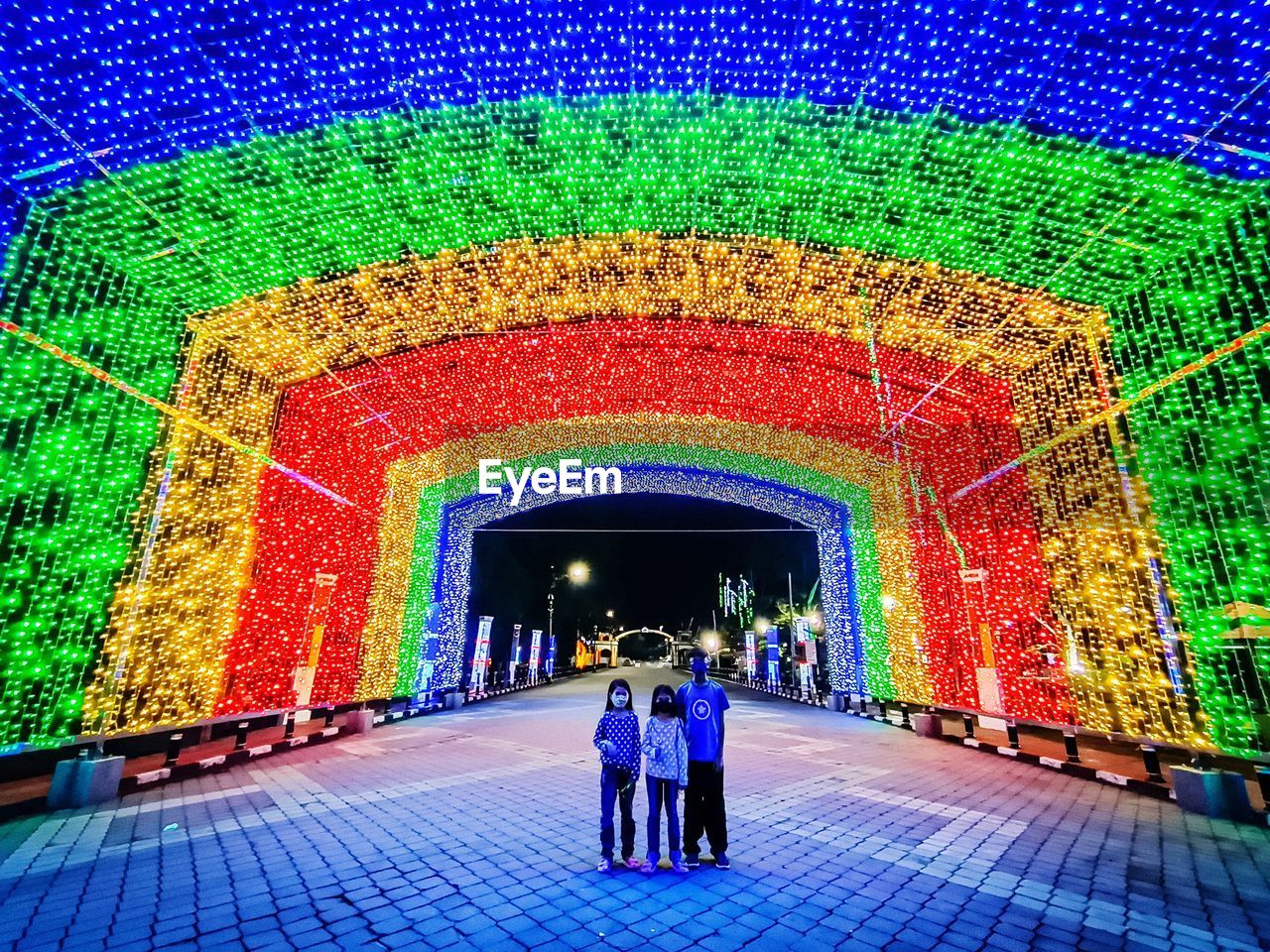 architecture, men, multi colored, illuminated, built structure, adult, two people, women, full length, arch, rear view, the way forward, walking, indoors, stage, lifestyles, togetherness, pattern, lighting equipment, standing, night, flooring, leisure activity