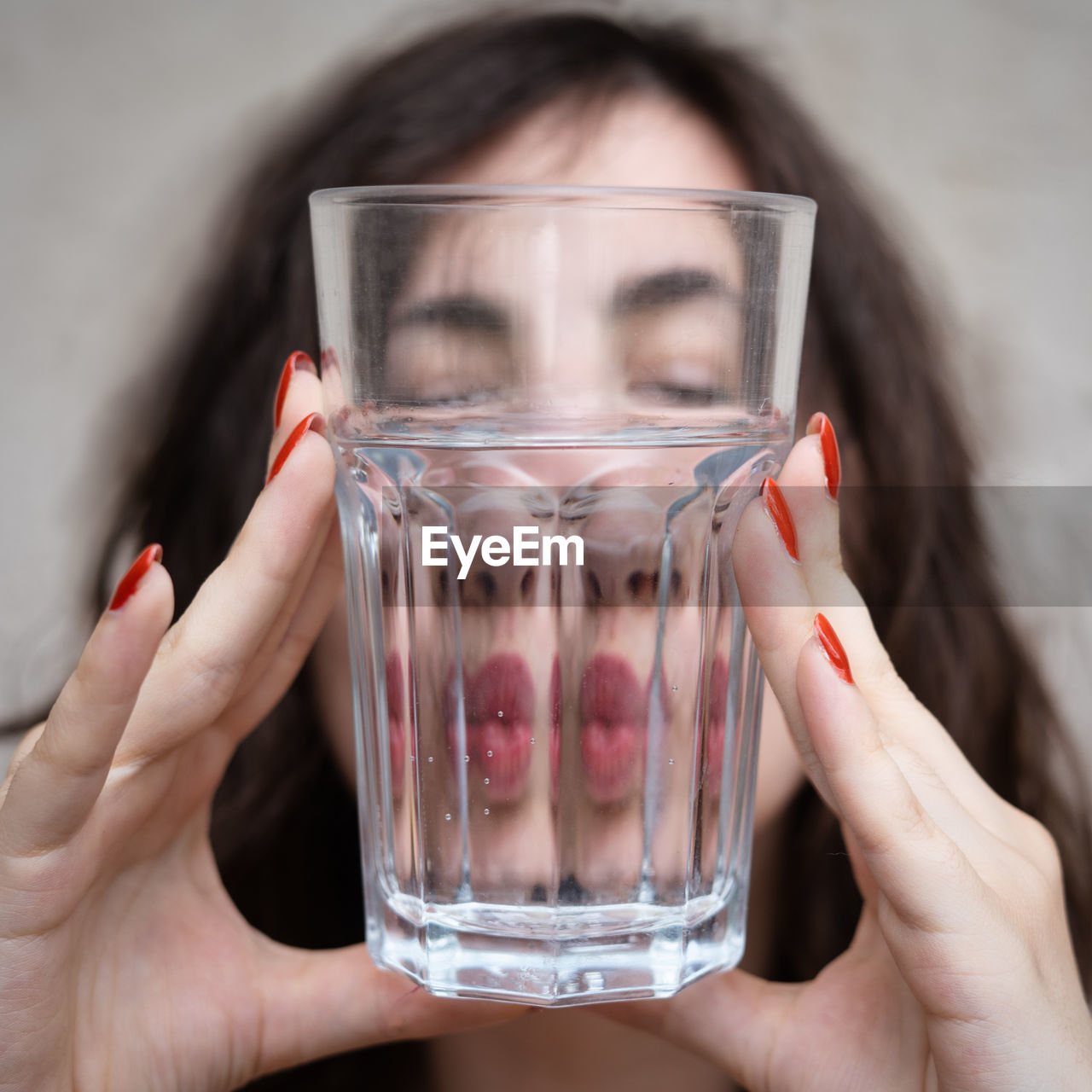 Woman with an empty glass of water