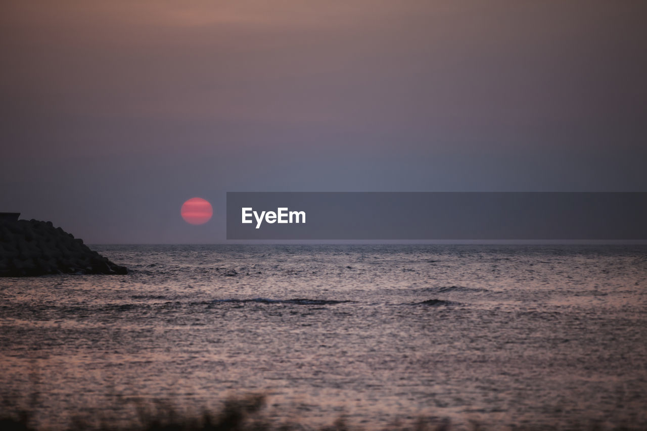 Scenic view of sea against clear sky during sunset