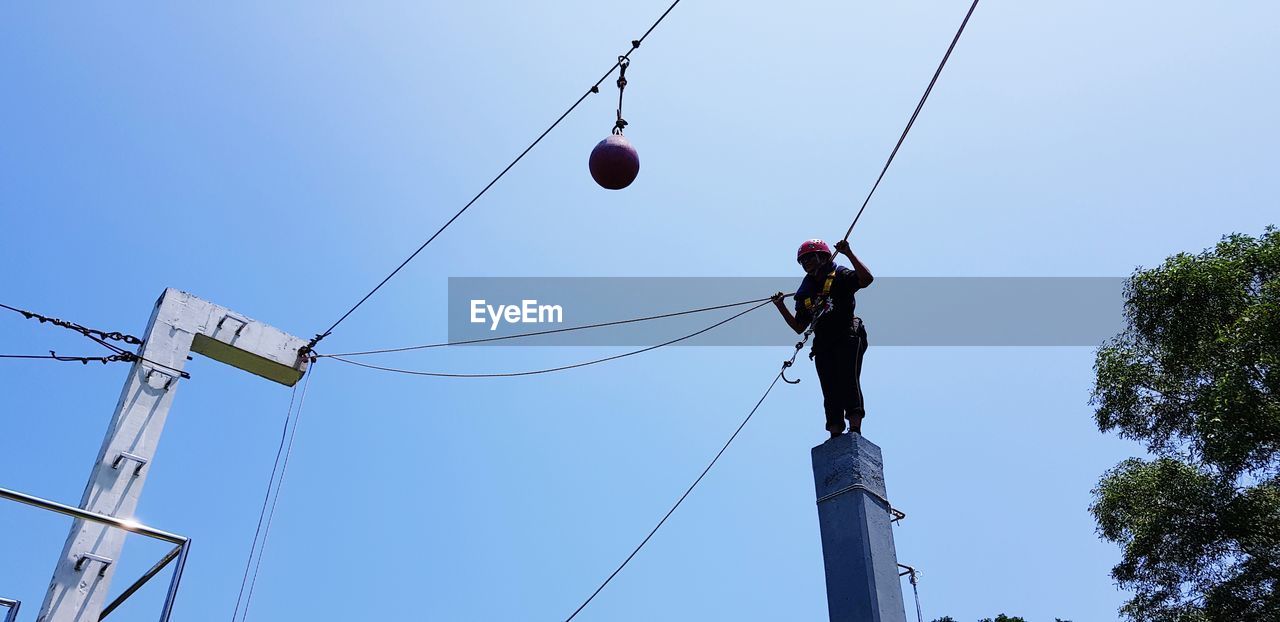 LOW ANGLE VIEW OF SKI AGAINST CLEAR SKY