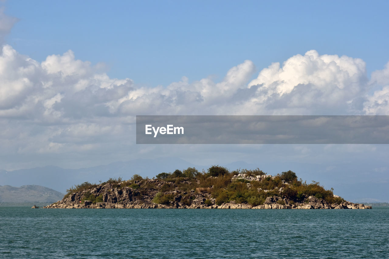 water, sea, sky, horizon, cloud, shore, ocean, body of water, land, nature, scenics - nature, coast, beauty in nature, island, travel destinations, travel, environment, beach, no people, bay, tranquility, islet, landscape, blue, tranquil scene, outdoors, tourism, coastline, day, tropical climate, holiday, rock, trip, architecture, vacation, idyllic, tree, seascape, summer, non-urban scene, plant, mountain, lagoon, building