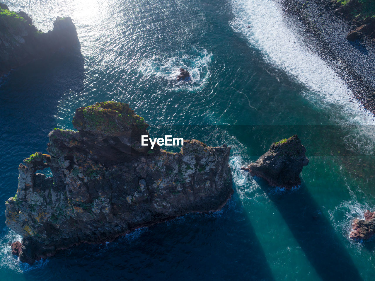 HIGH ANGLE VIEW OF PEOPLE ON ROCK