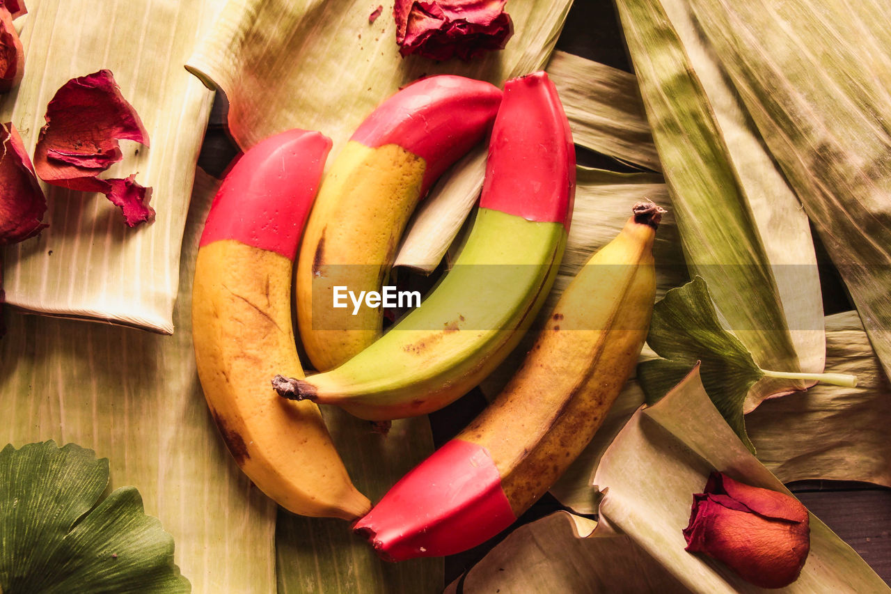 food and drink, food, healthy eating, banana, fruit, freshness, wellbeing, wood, plant, produce, still life, high angle view, red, no people, indoors, vegetable, table, flower, variation, organic, cooking plantain, studio shot, yellow