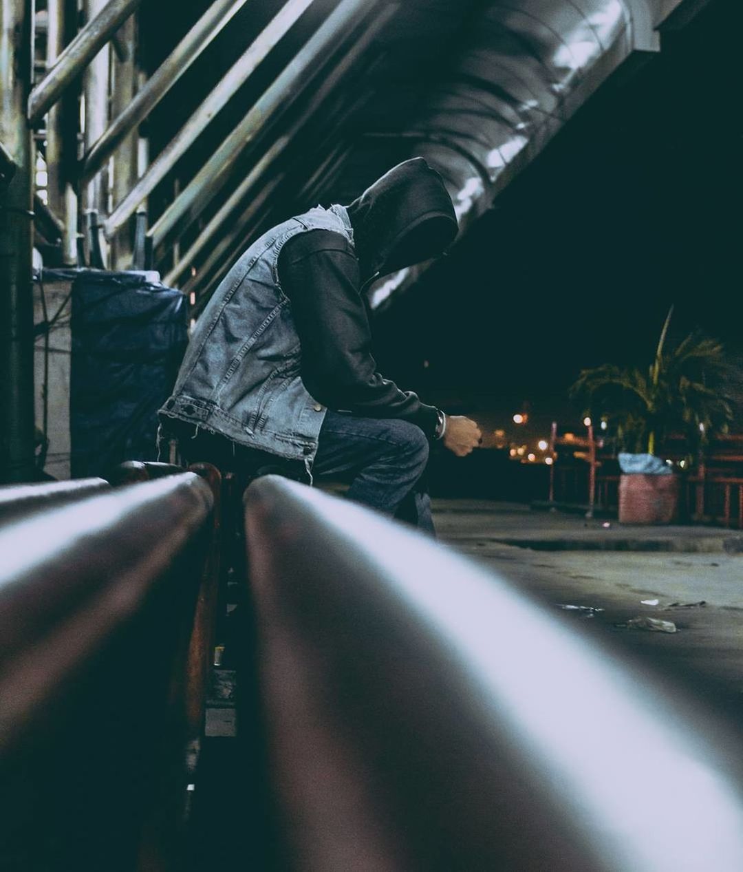 LOW SECTION OF MAN ON ILLUMINATED STREET AT NIGHT