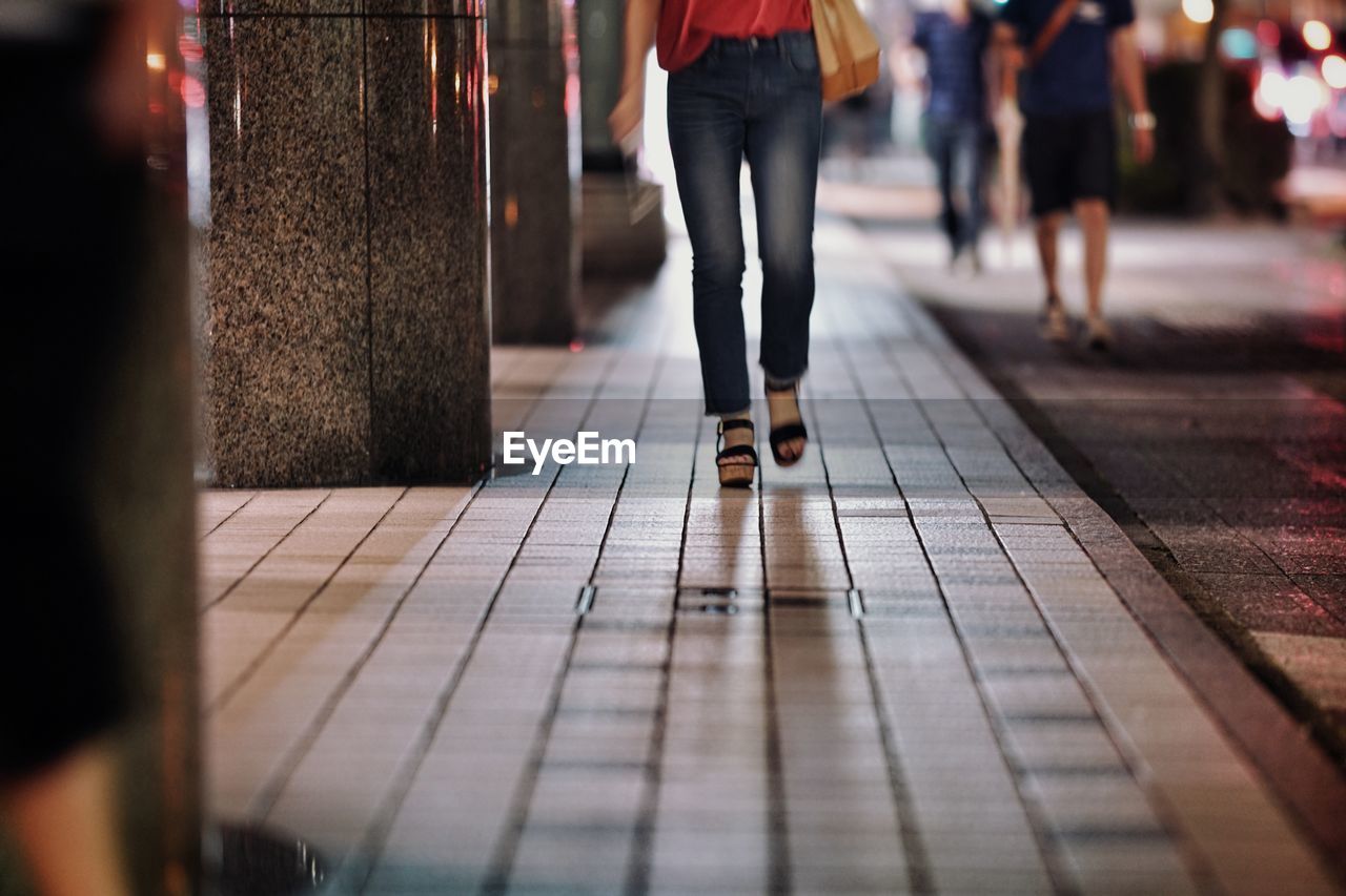 Low section of women walking on floor