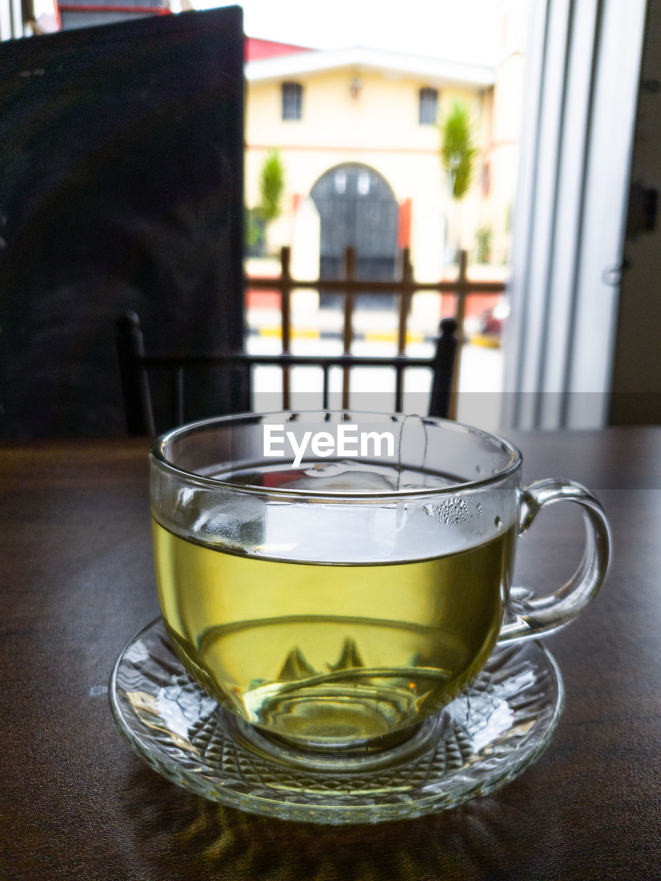 drink, food and drink, refreshment, mug, cup, table, hot drink, tea, indoors, household equipment, crockery, no people, tea cup, window, glass, focus on foreground, coffee, drinking glass, saucer, architecture, cafe, close-up, freshness, coffee cup, food, day