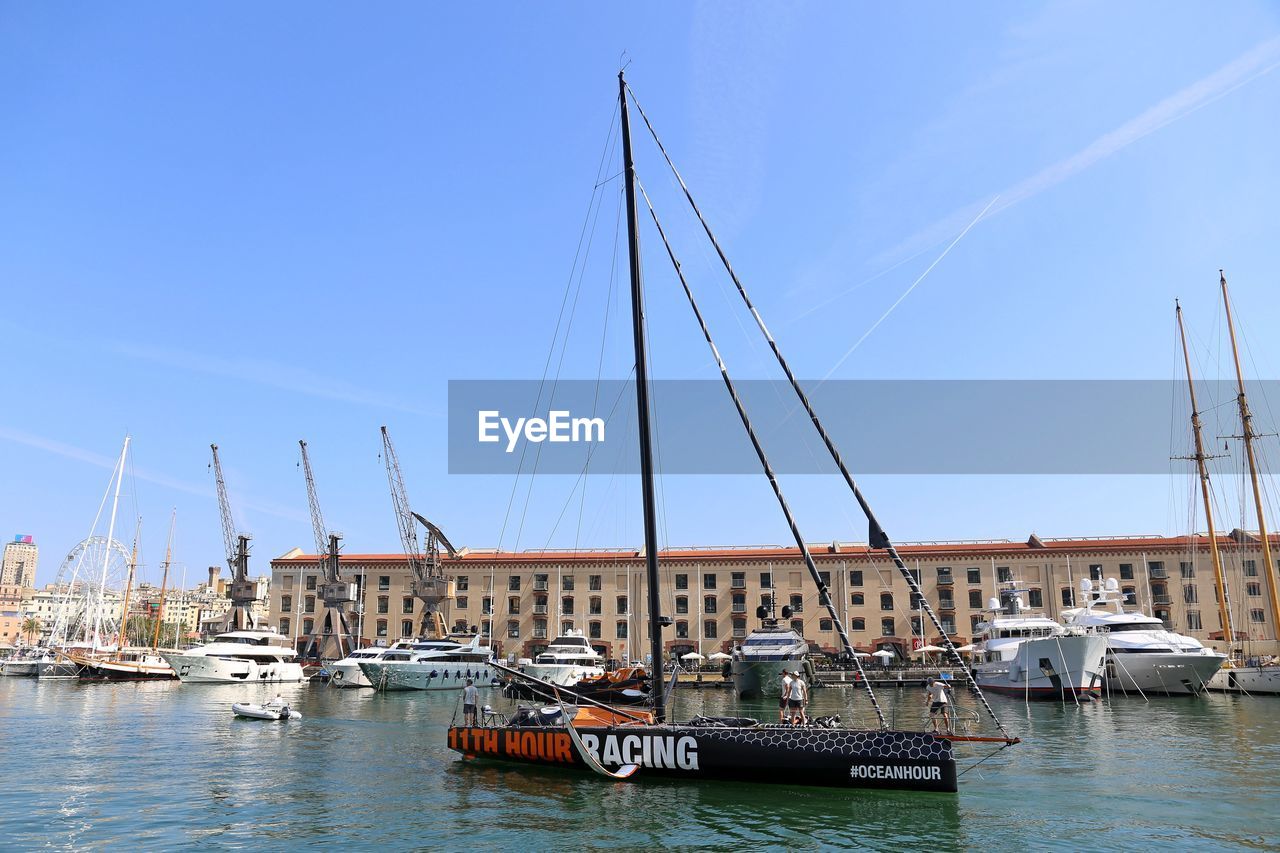 SAILBOATS MOORED IN RIVER