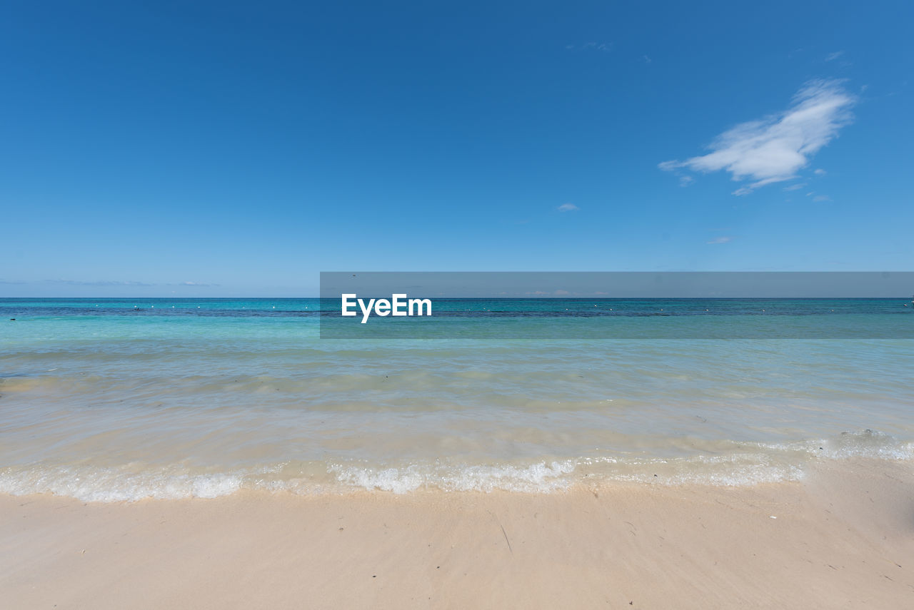 Scenic view of sea against blue sky