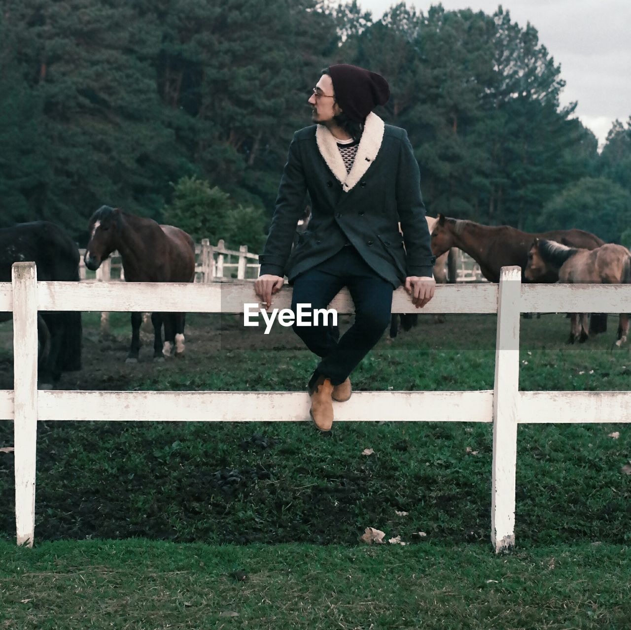 WOMAN STANDING ON TREE TRUNK