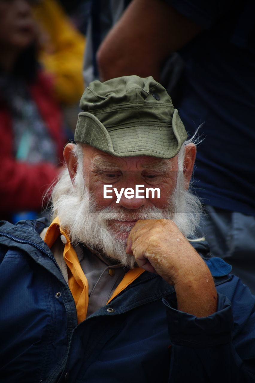 Thoughtful bearded mature man in city