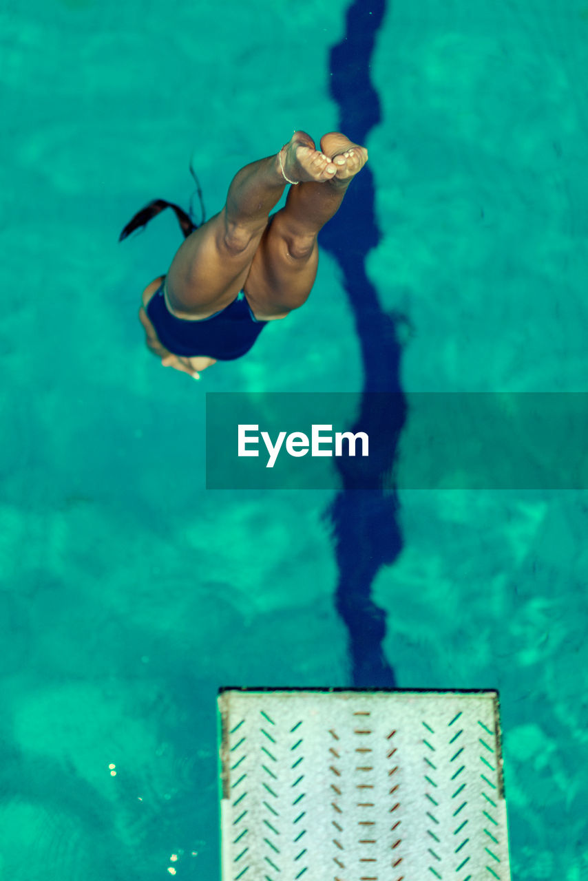 High angle view of swimmer diving into swimming pool