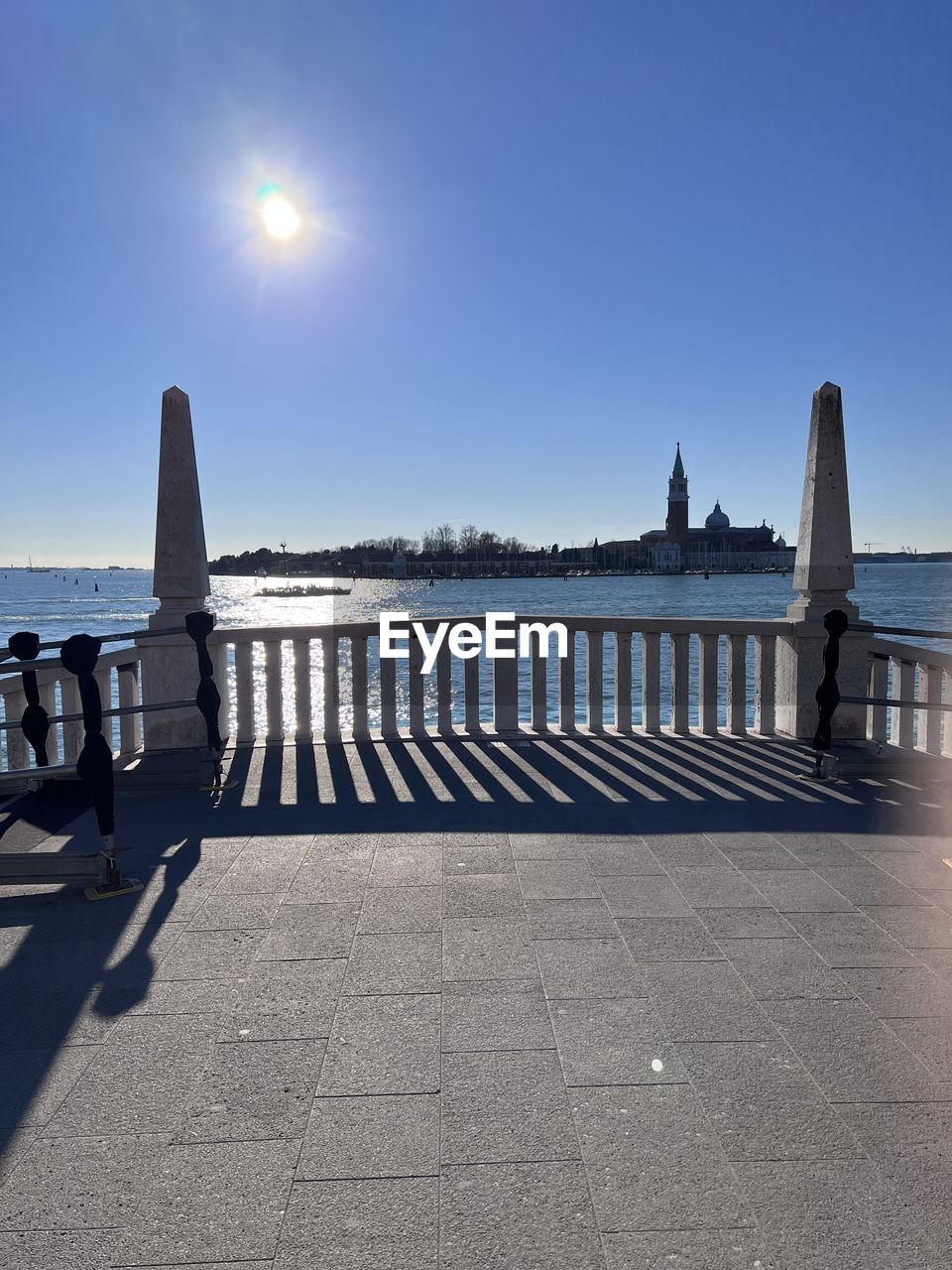 sky, architecture, built structure, sunlight, blue, nature, skyscraper, no people, lighting, low angle view, building exterior, tower, day, clear sky, sunny, light, outdoors, street light, sun, city, building, lens flare