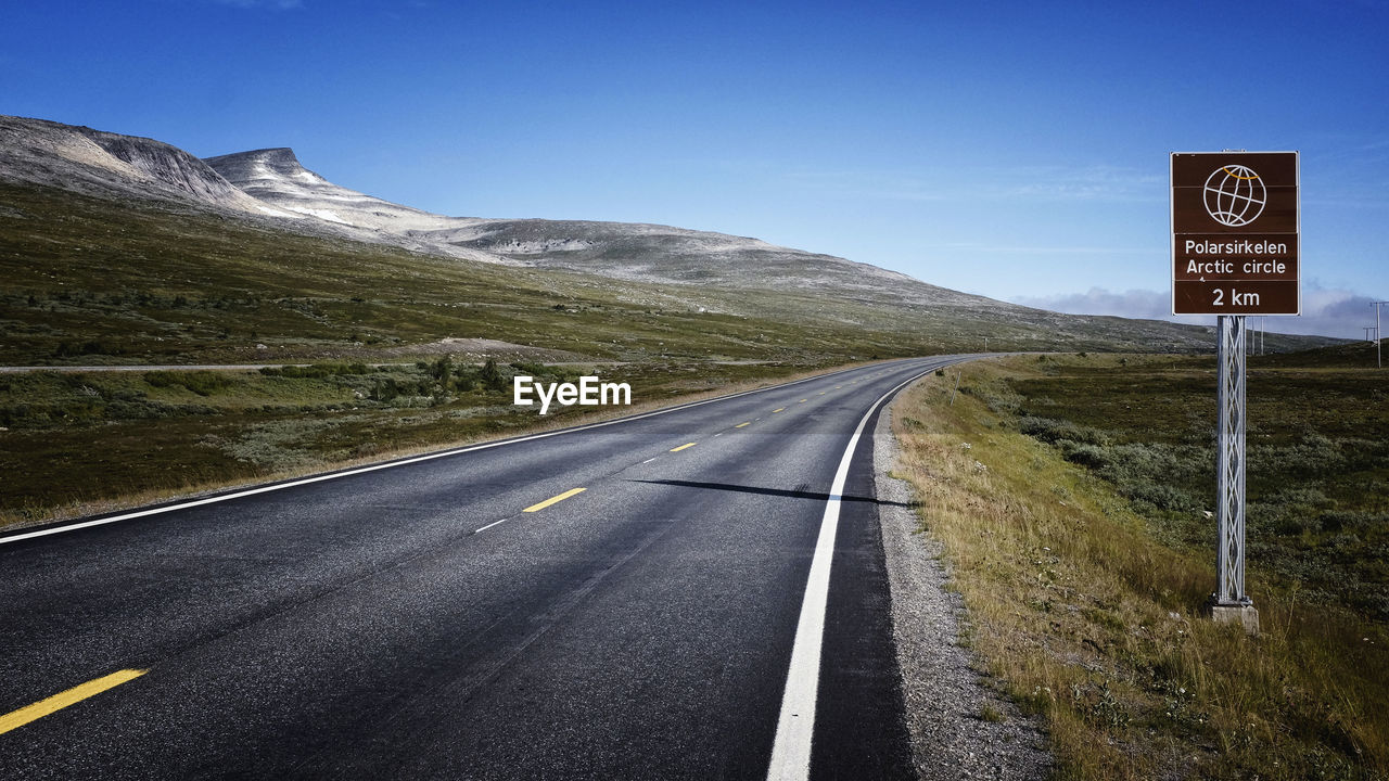 Country road leading towards mountains