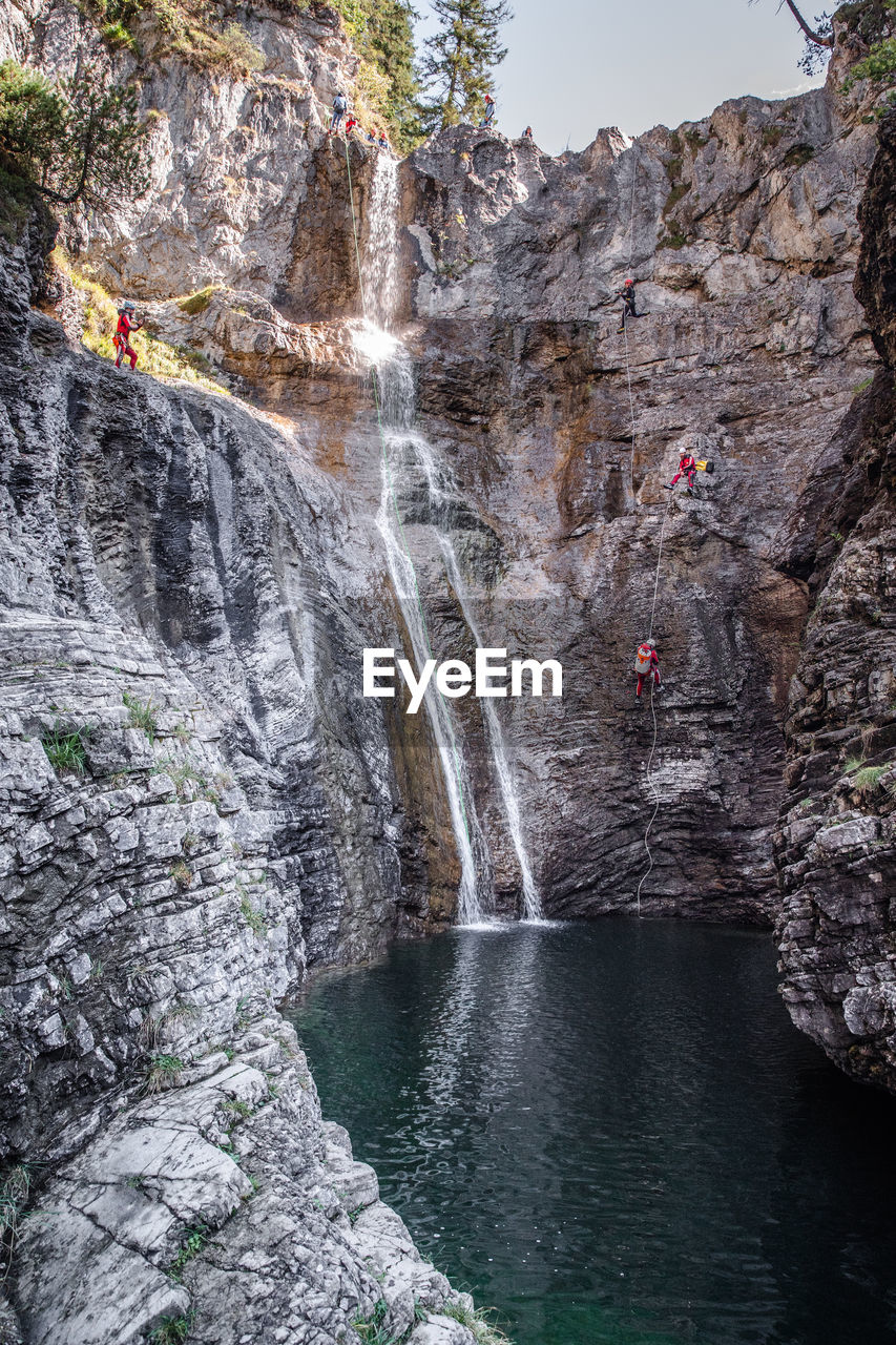 VIEW OF WATERFALL ON ROCK FORMATION