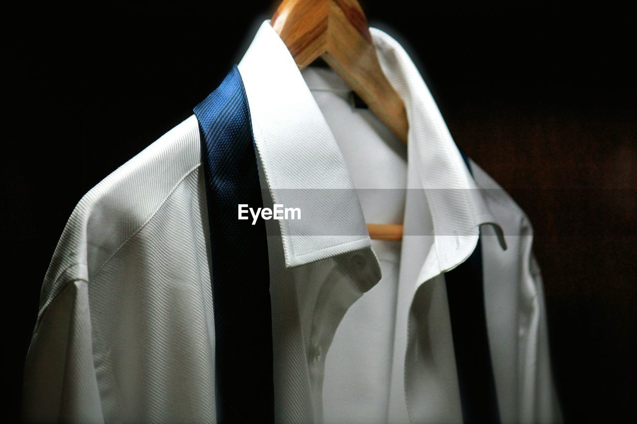 Close-up of clothes hanging against black background