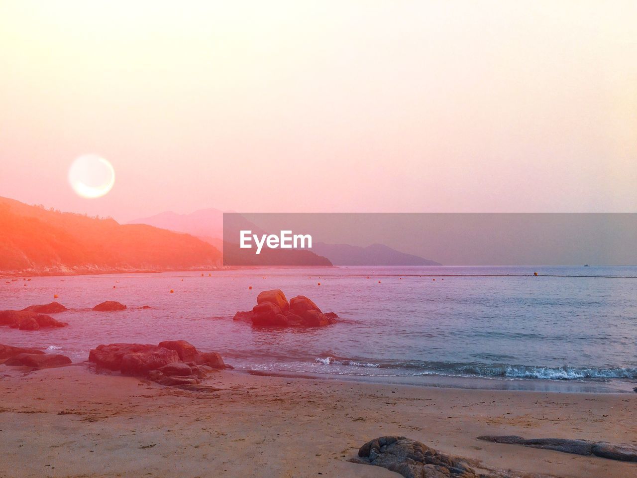 Scenic view of sea against clear sky during sunset