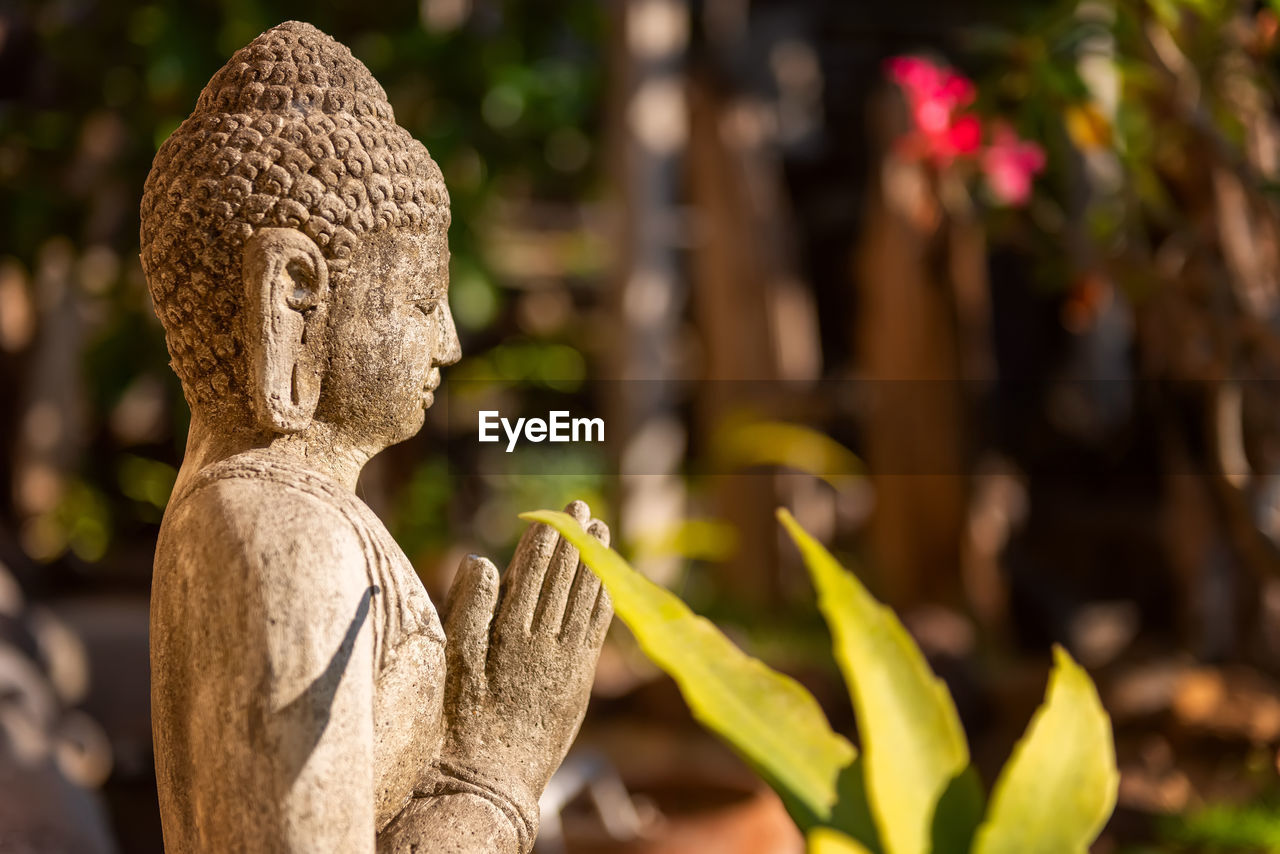 Traditional stone sculpture of buddha. interior detail from a luxury hotel resort. bali, indonesia