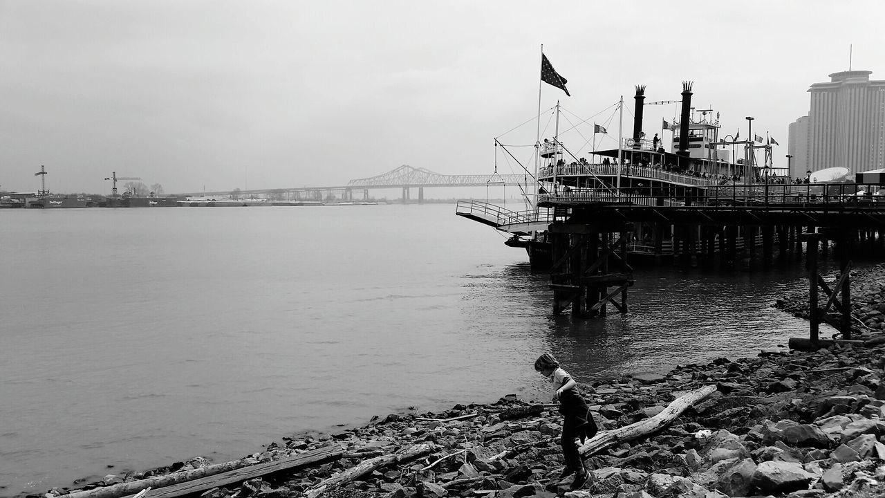 Boy standing by mississippi river