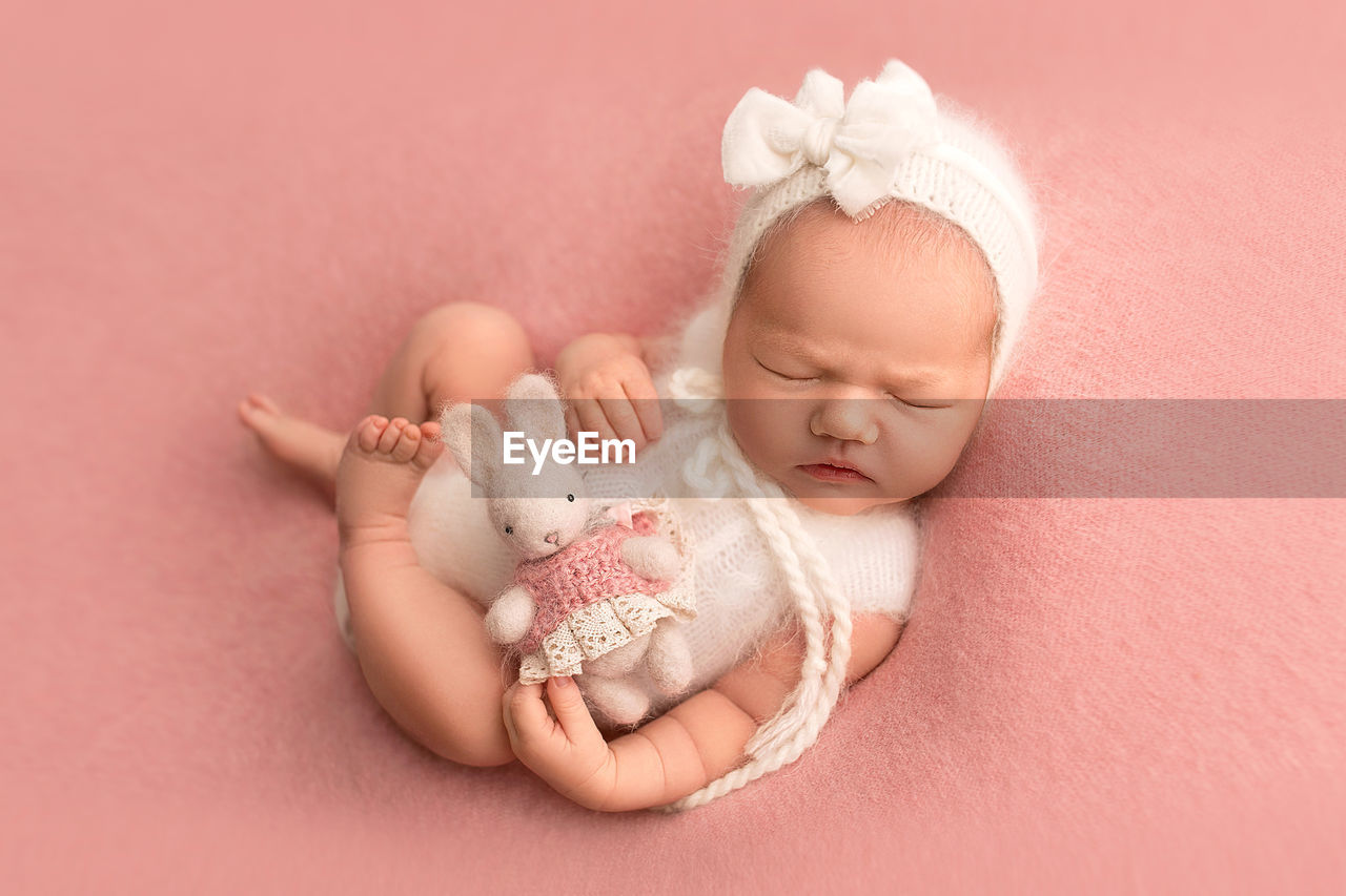 cropped hand of woman holding newborn girl