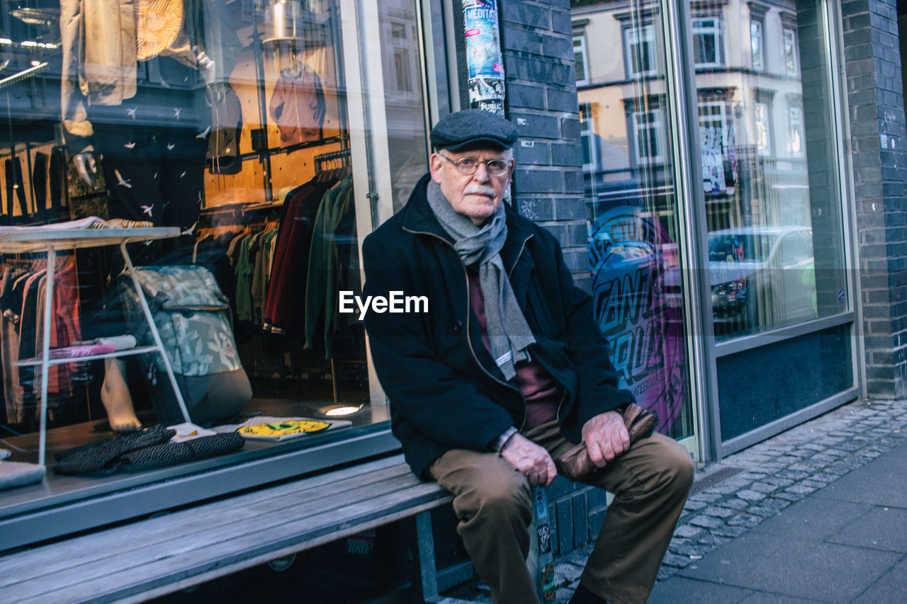 FULL LENGTH OF MAN SITTING AT WINDOW