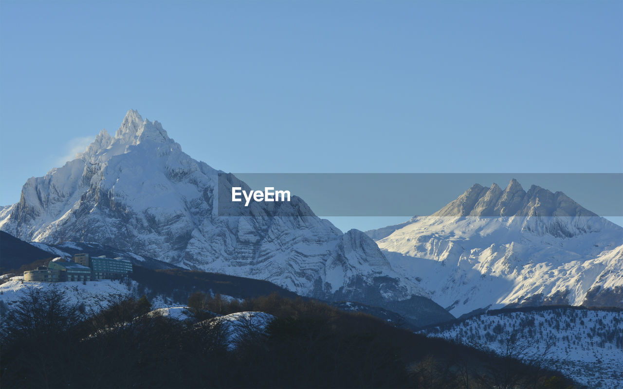 Scenic view of snowcapped mountains against clear sky