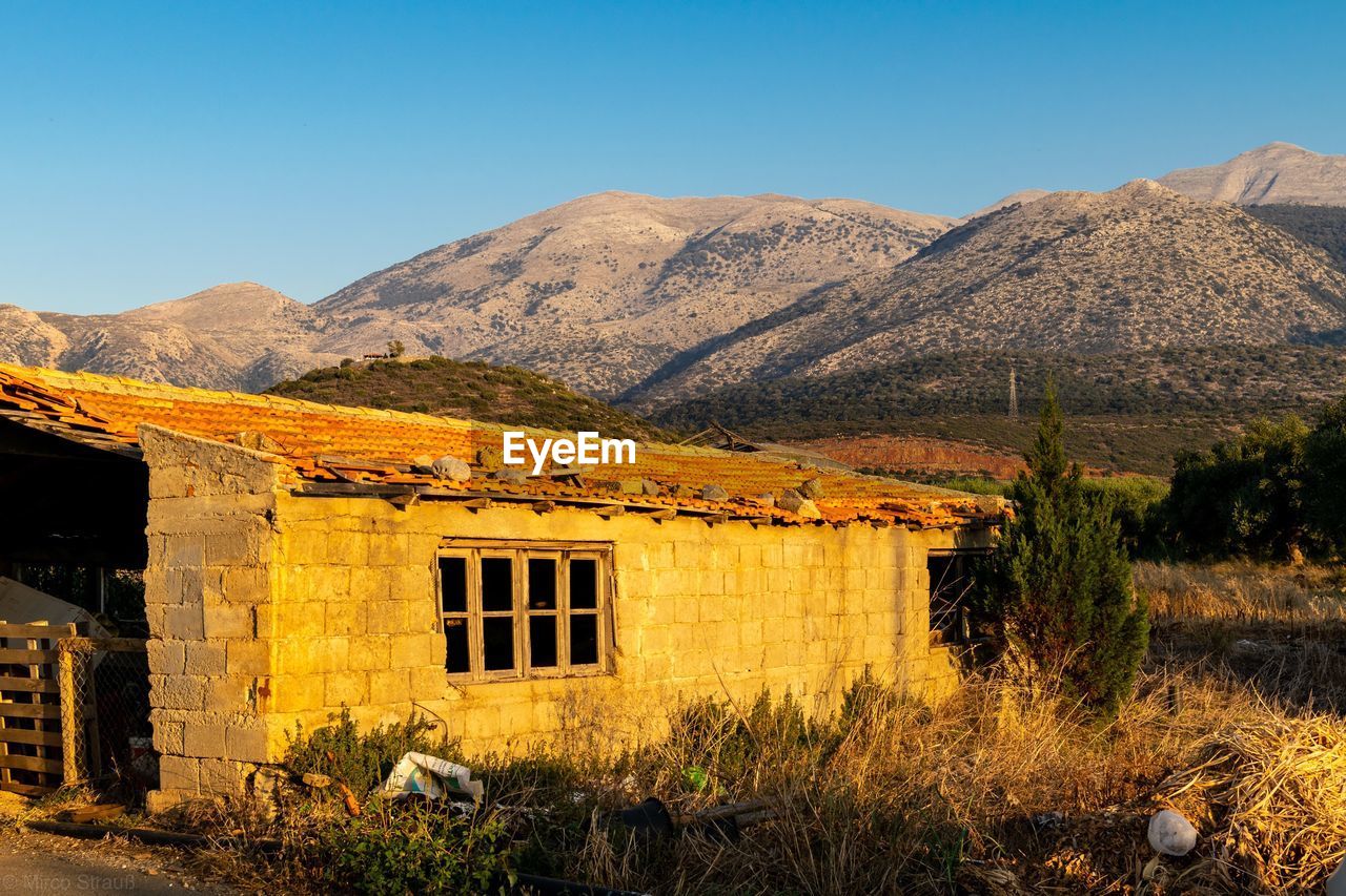 House on mountain against sky
