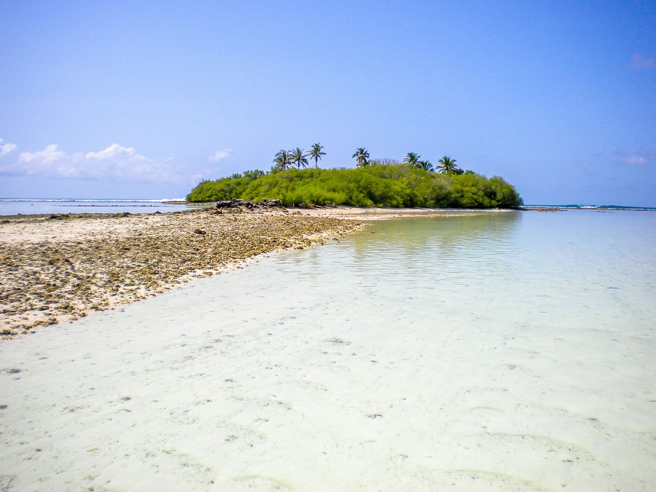 Scenic view of island against blue sky