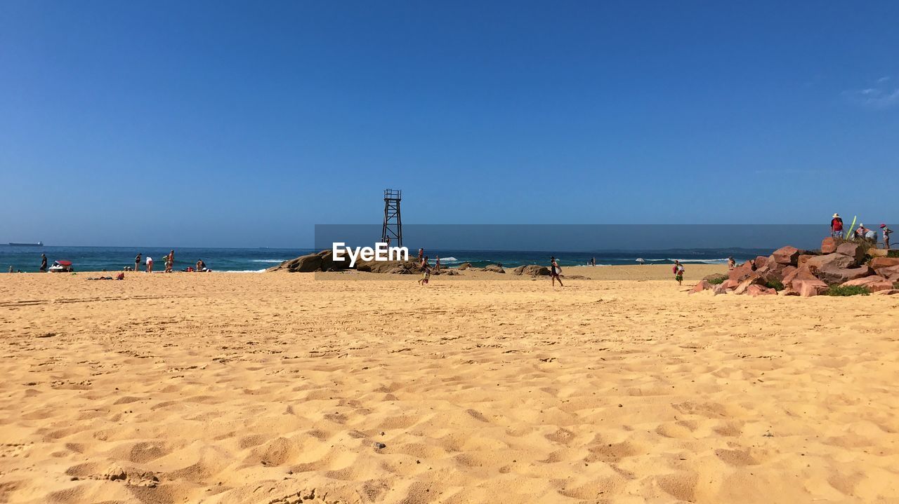 PANORAMIC VIEW OF BEACH AGAINST CLEAR BLUE SKY
