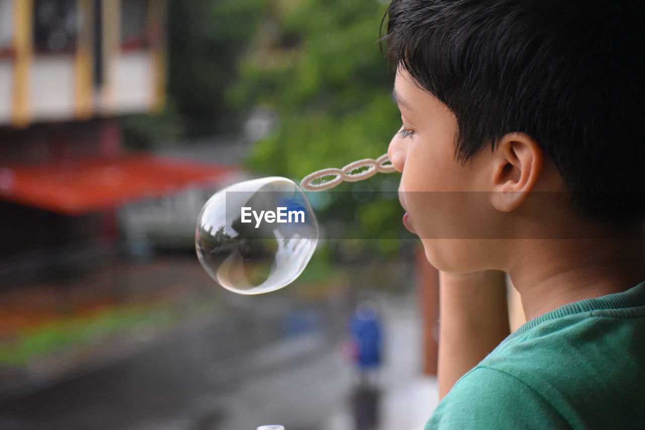 Portrait of boy holding bubbles