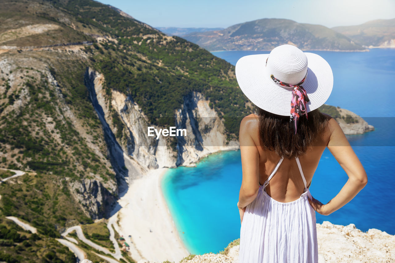 Rear view of woman wearing hat looking at view