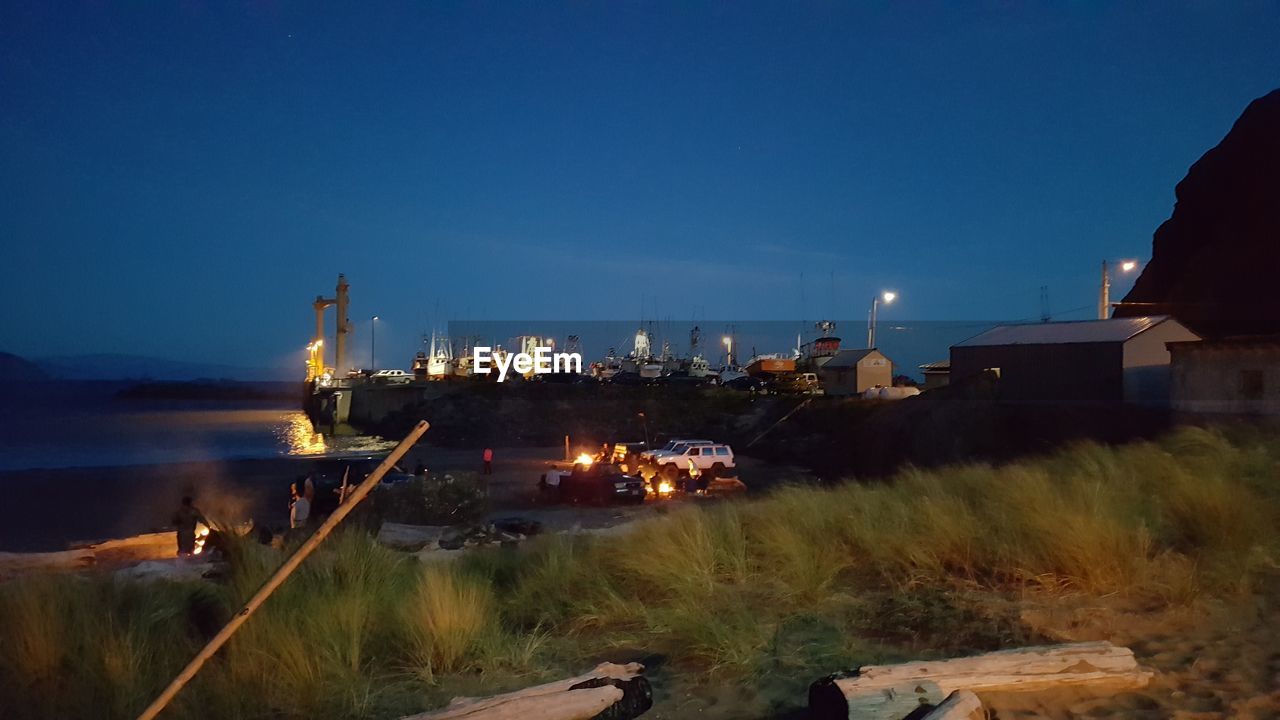 VIEW OF ILLUMINATED BUILDINGS AGAINST CLEAR SKY