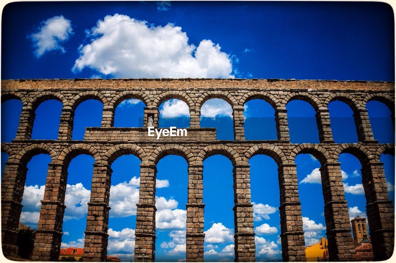 LOW ANGLE VIEW OF BUILT STRUCTURES AGAINST BLUE SKY