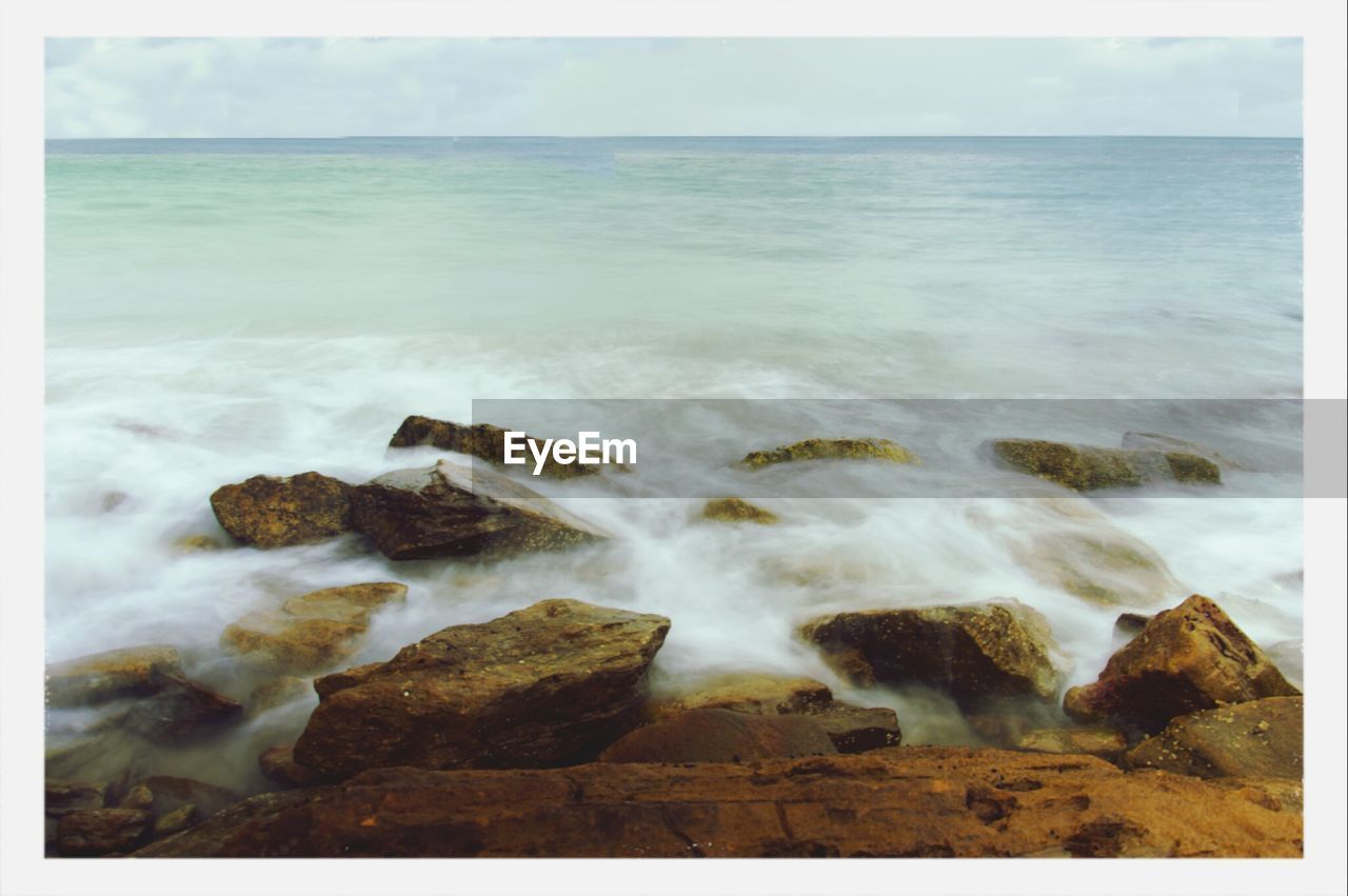 Rocky shore against sea