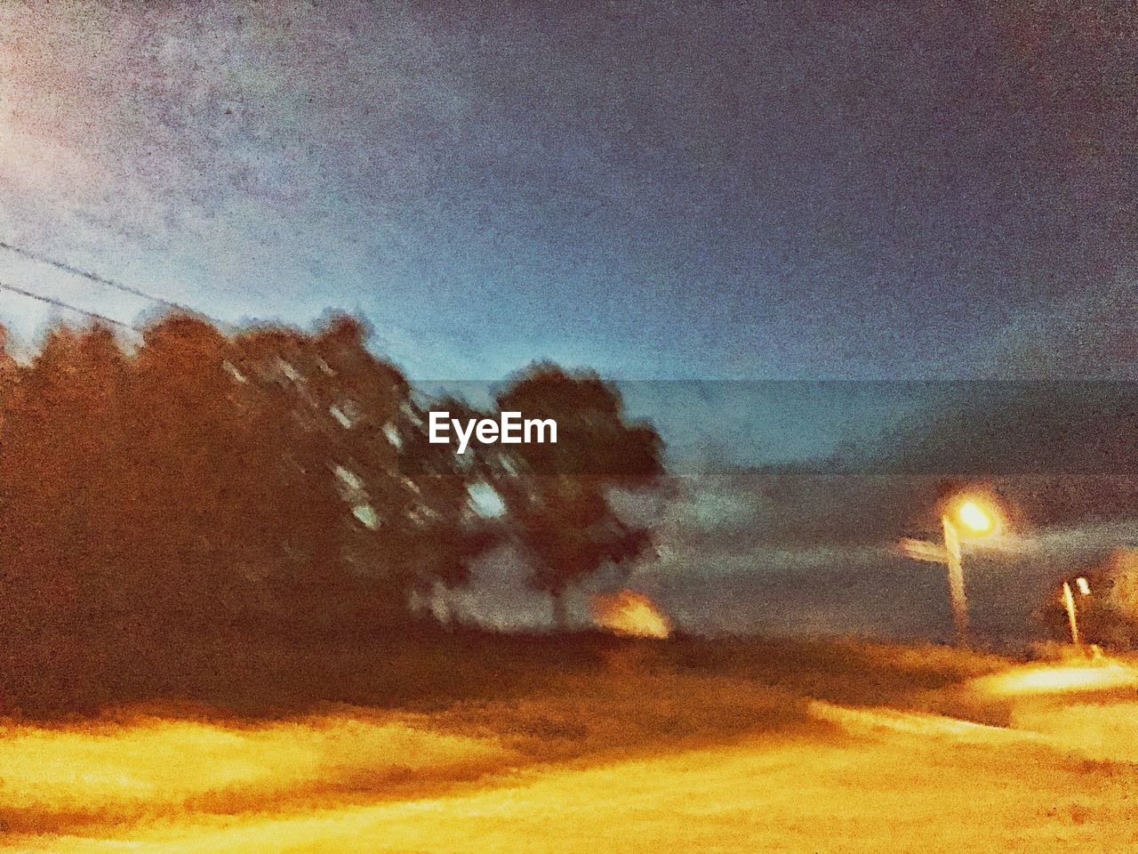 ILLUMINATED ROAD AGAINST SKY