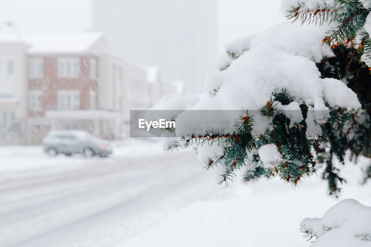 Snow covered car in city