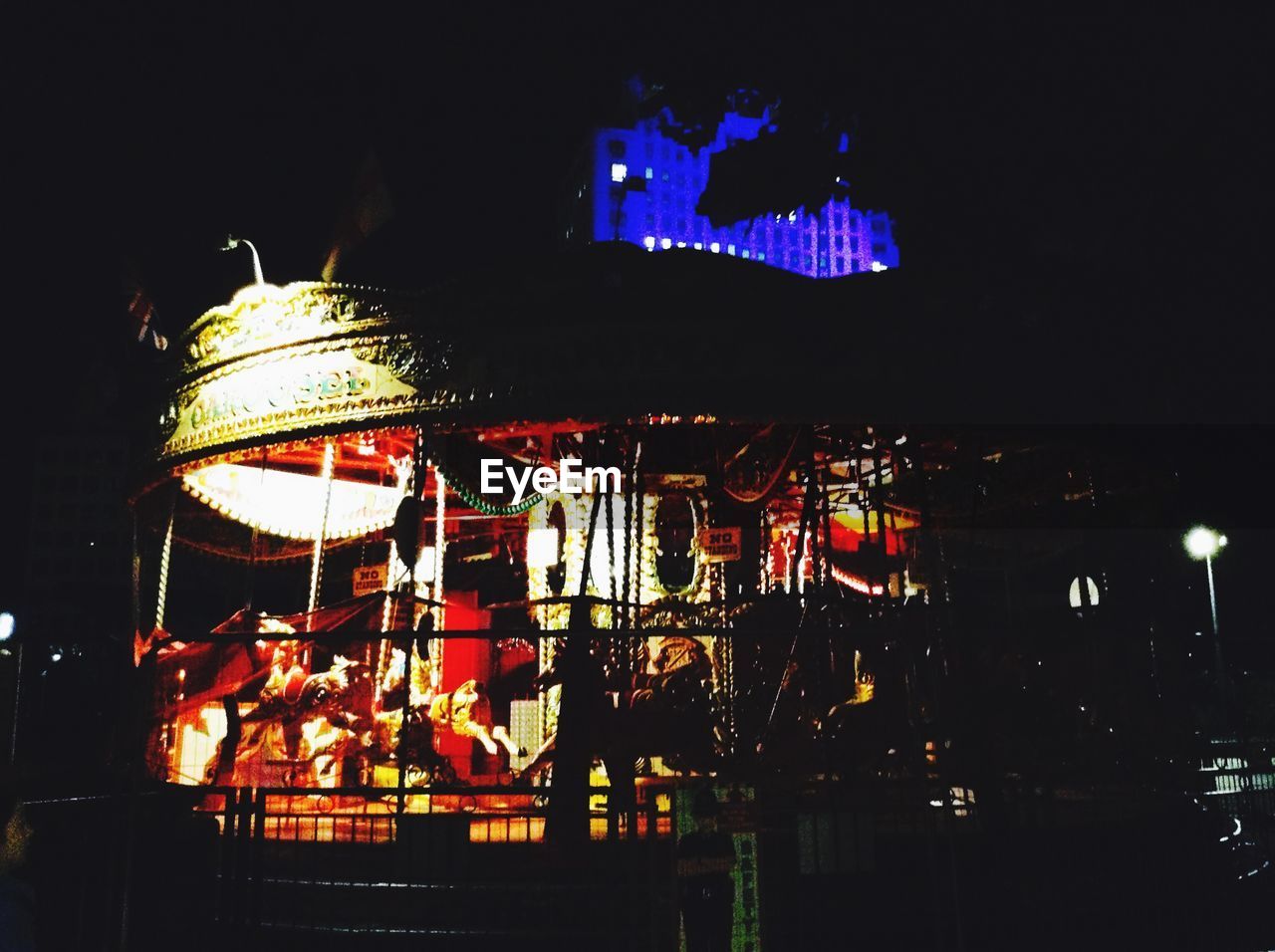 VIEW OF ILLUMINATED CITY AT NIGHT