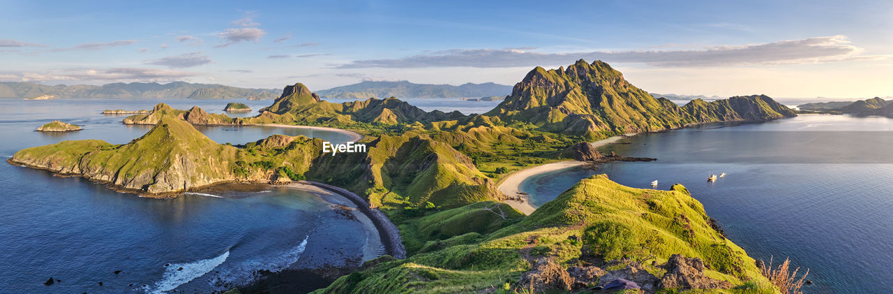 Panoramic view of sea and mountains against sky