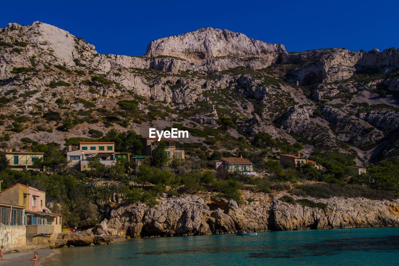 Scenic view of rocky mountain by sea