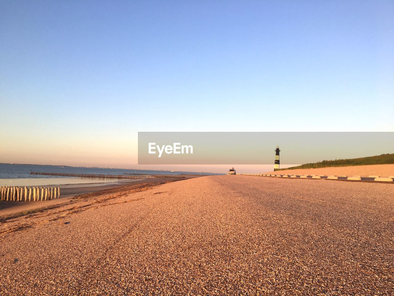 Scenic view of beach against clear blue sky