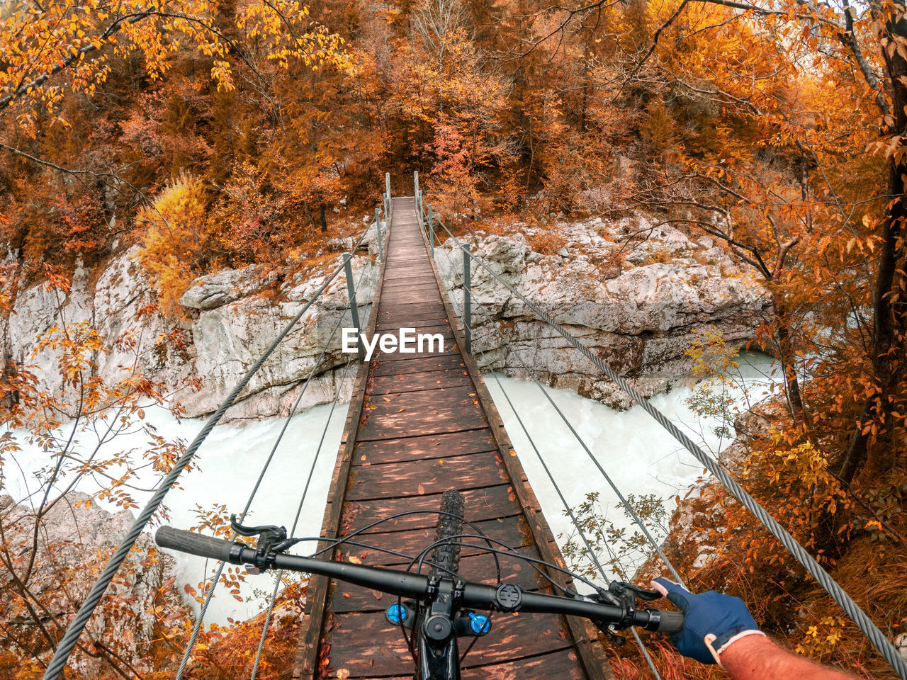 Gopro first person view mountain biking on  wooden suspension bridge above soca river, slovenia.