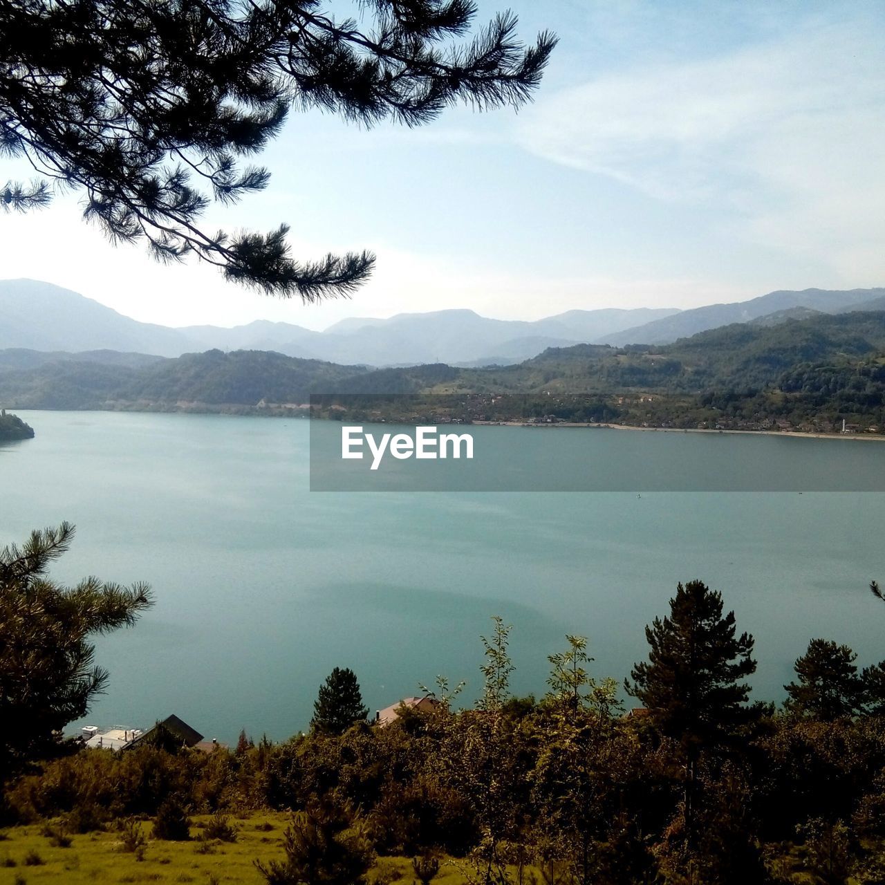 SCENIC VIEW OF LAKE AND MOUNTAINS