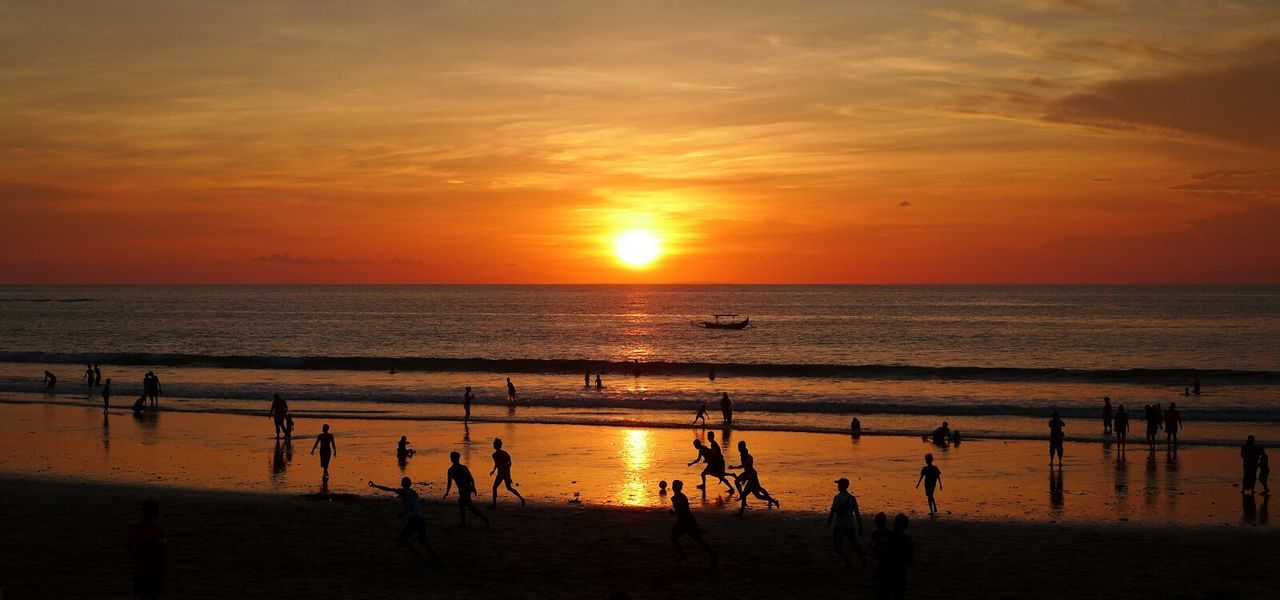 Silhouette people enjoying on beach during sunset at bali