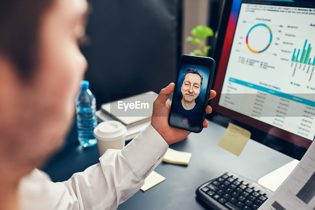 Man entrepreneur having business conversation on mobile phone. businessman working with data charts