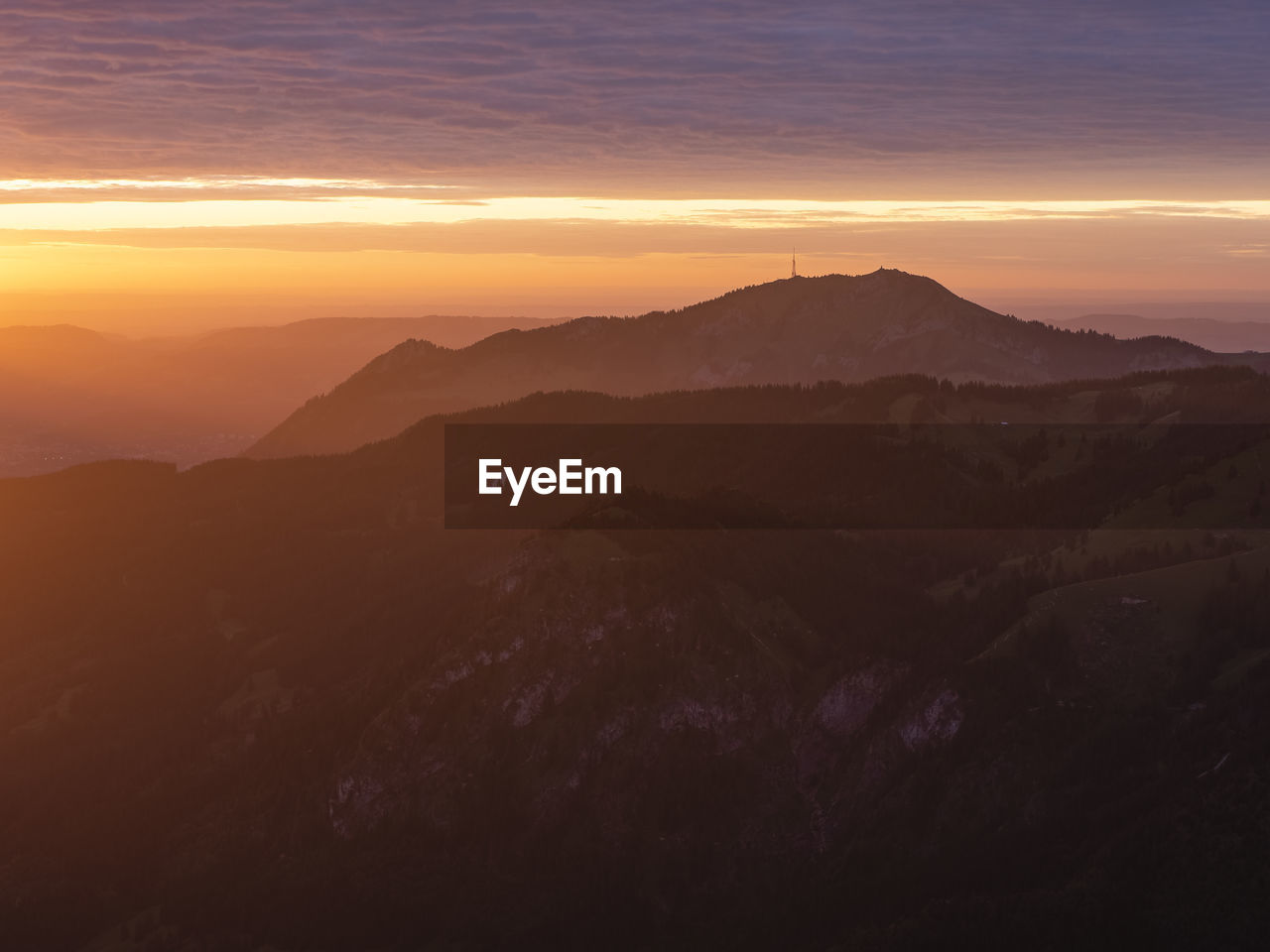 Scenic view of silhouette mountains against sky during sunset