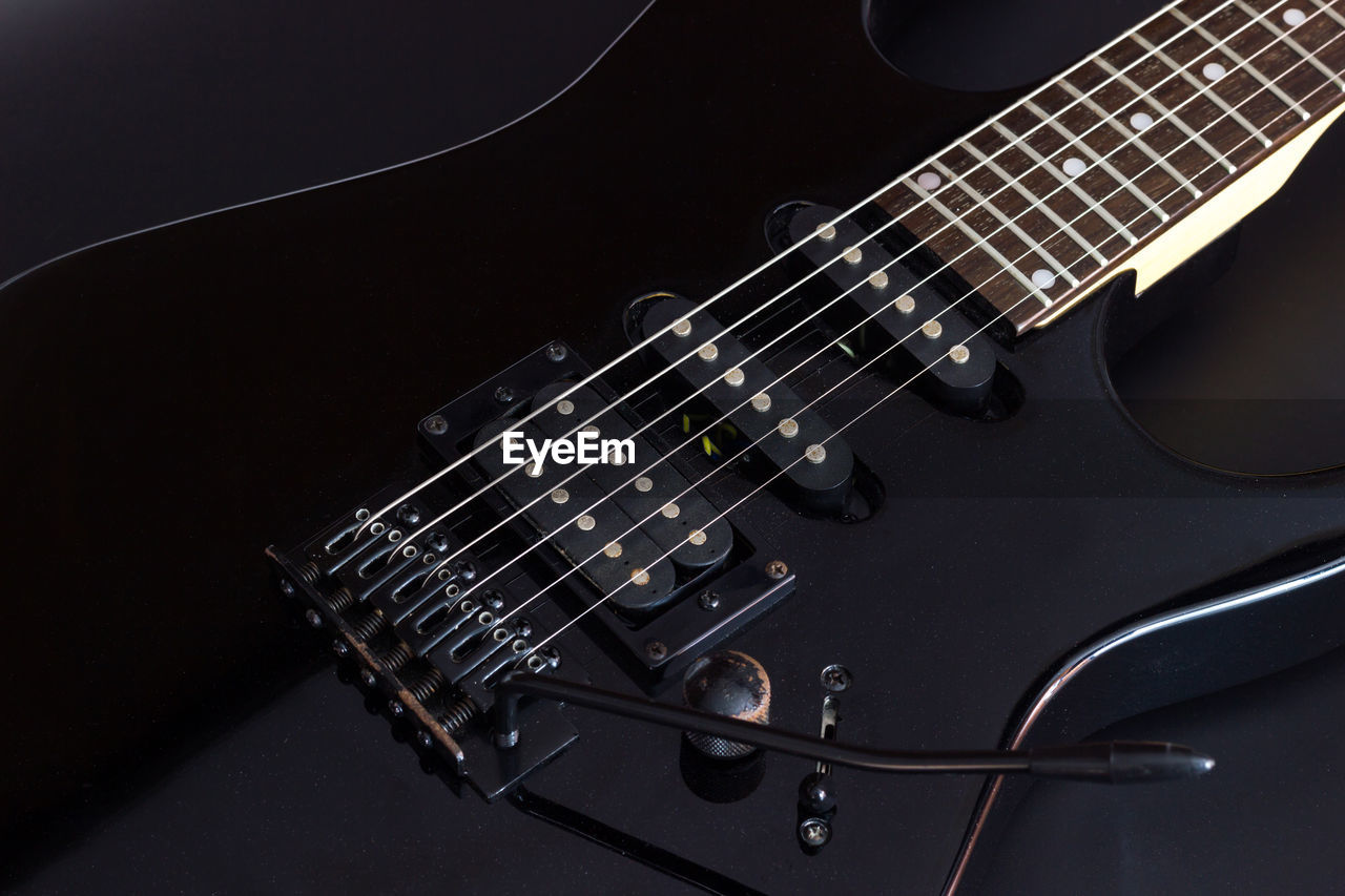 Close-up of guitar against black background