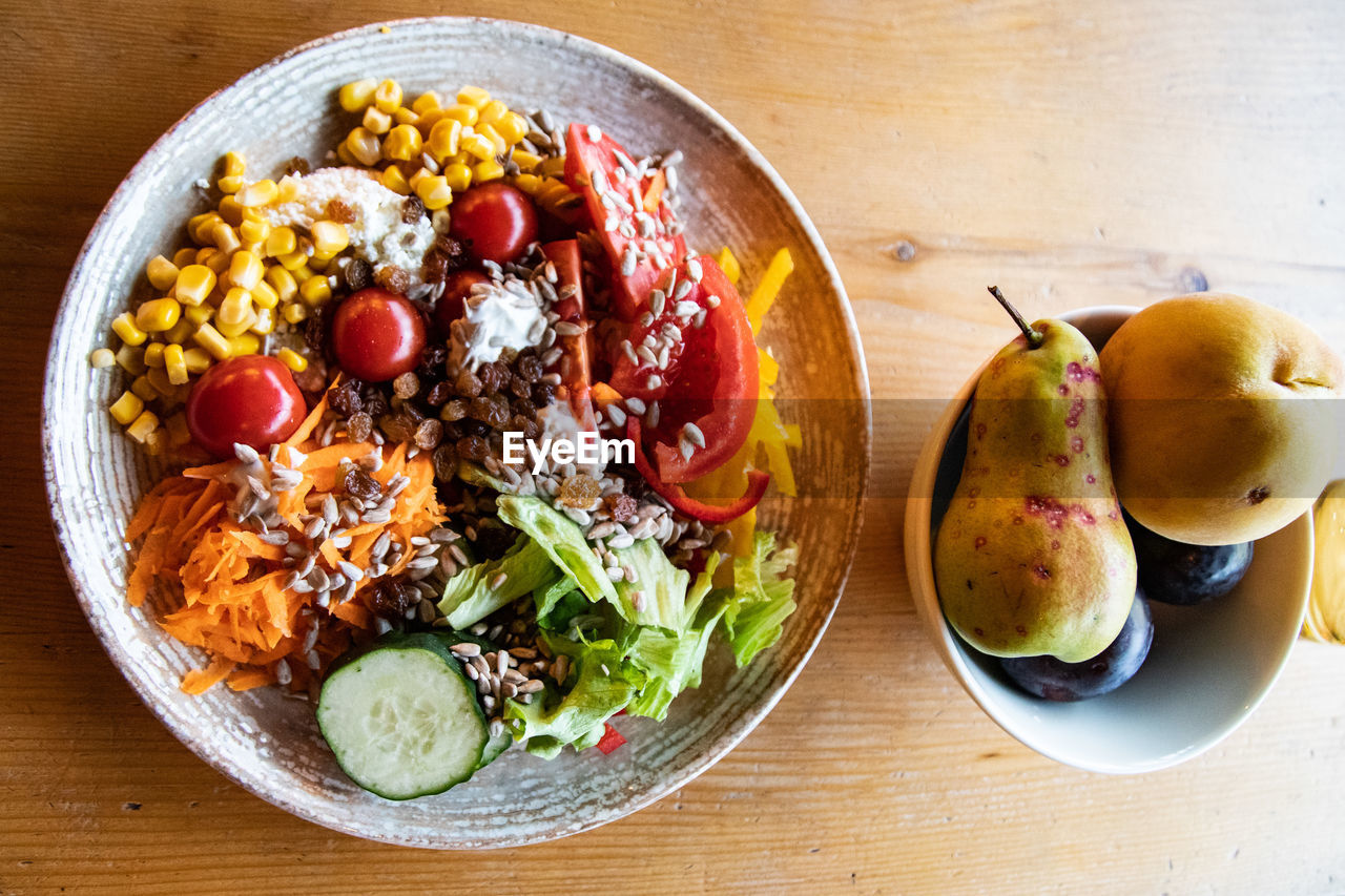 food and drink, food, healthy eating, wellbeing, freshness, fruit, bowl, dish, table, vegetable, meal, indoors, high angle view, cuisine, wood, no people, produce, plate, salad, lunch, still life, directly above, breakfast